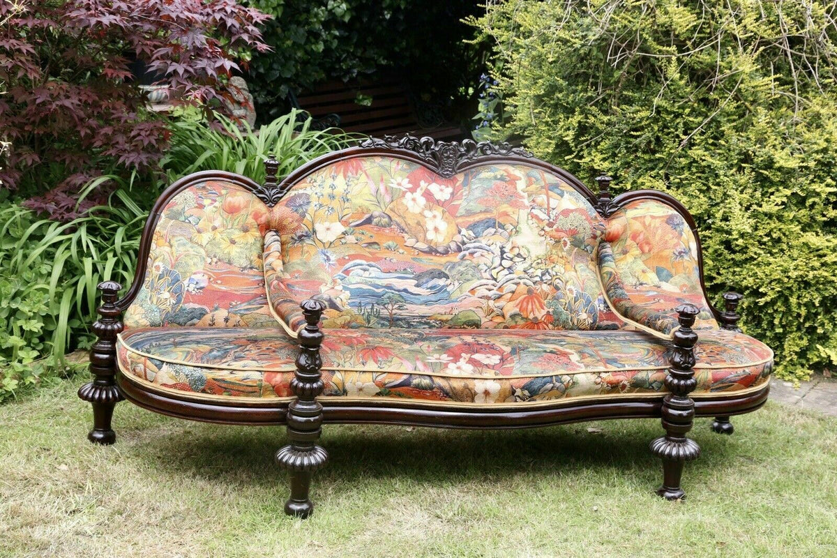 Victorian rosewood conversation seat, front view in a garden