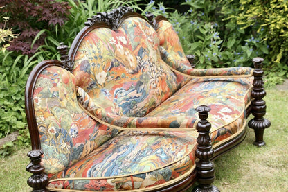 Victorian conversation seat, close-up of carved crest and serpentine back