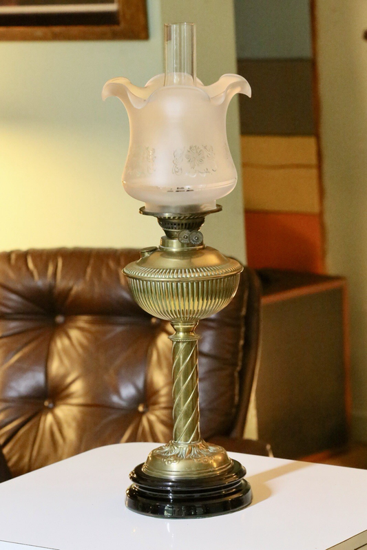 Fine Victorian Art Nouveau brass oil lamp with reeded font, twisted column, etched frosted tulip shade and black base