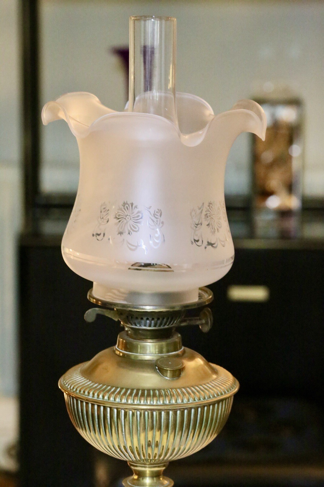 Close-up of reeded brass font and frosted shade