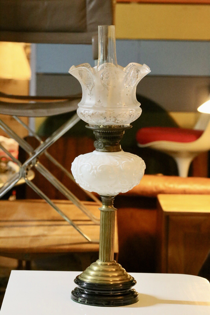 Fine Victorian Art Nouveau brass oil lamp with embossed milk glass reservoir, etched frosted tulip shade and black base