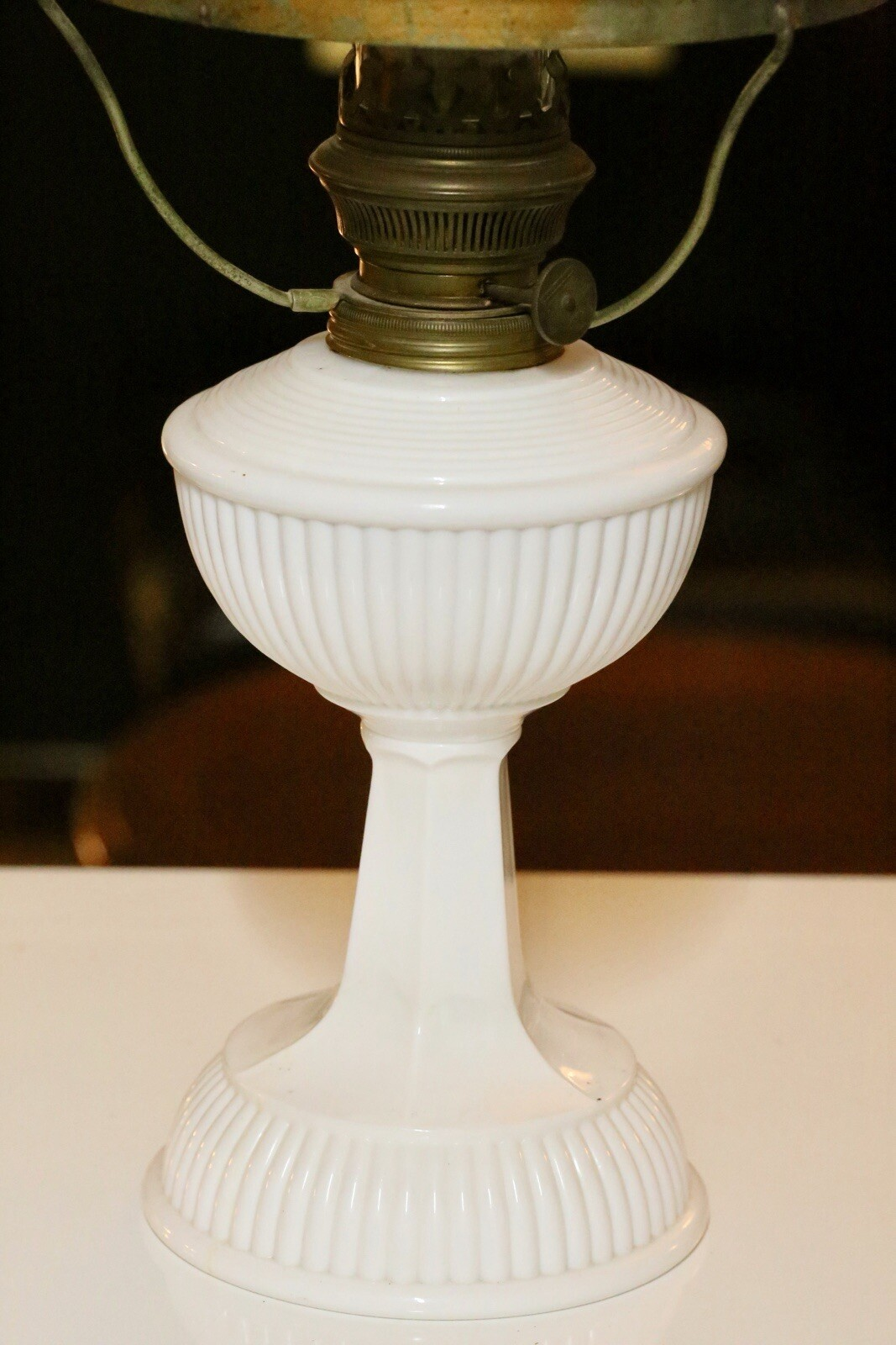 Close-up of ribbed milk glass font and pedestal base