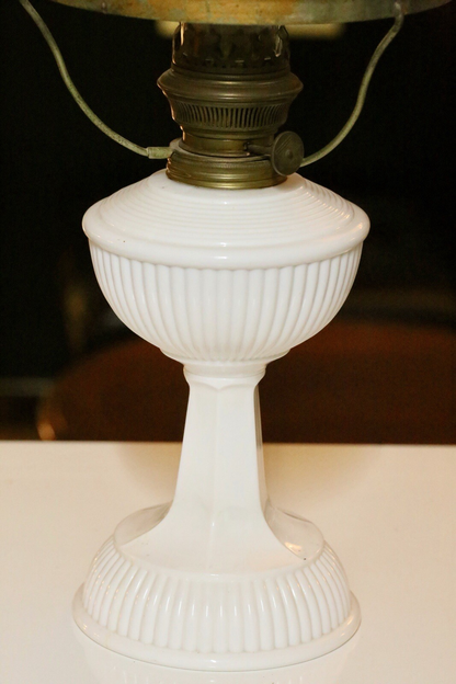 Close-up of ribbed milk glass font and pedestal base