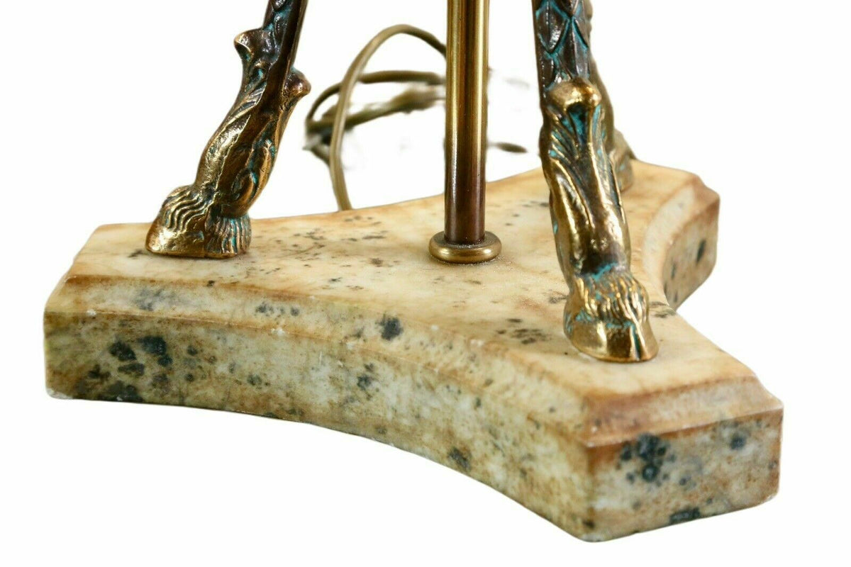 Close-up of brass hoof feet and alabaster plinth base