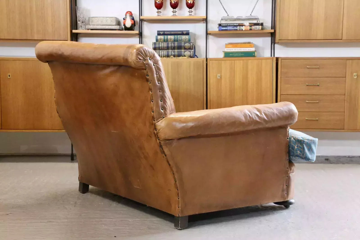 Brown leather loveseat armchair, rear three-quarter view