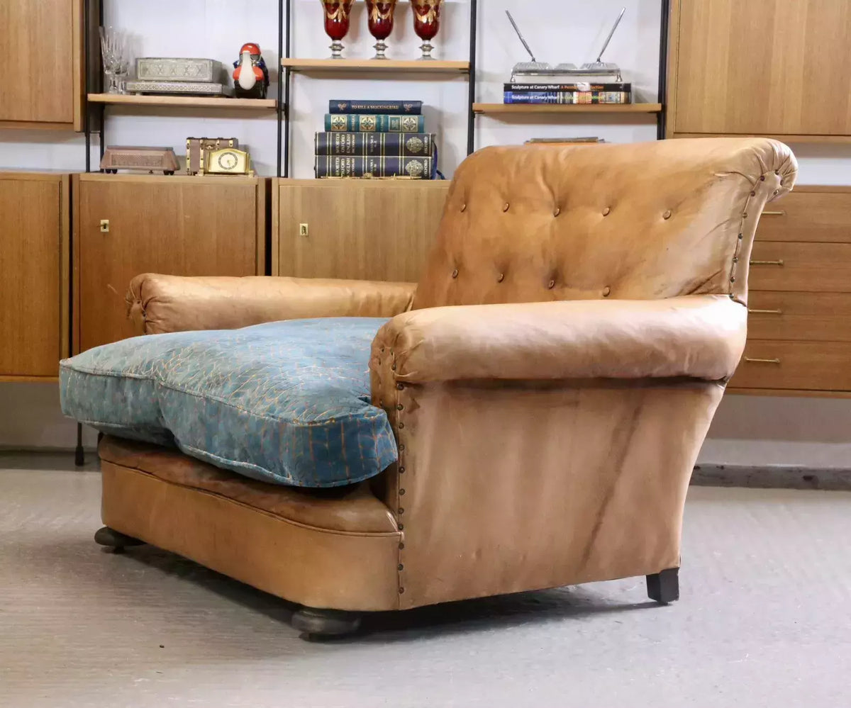 French Art Deco style brown leather loveseat armchair, three-quarter view from the right