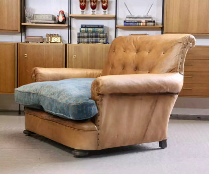 French Art Deco style brown leather loveseat armchair, three-quarter view from the right