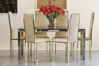 Set of Renato Zevi gilt dining chairs around a table with flowers