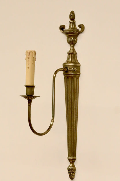Large French neoclassical brass wall sconce with urn finial, fluted tapering backplate, single arm and acorn drop, 51cm