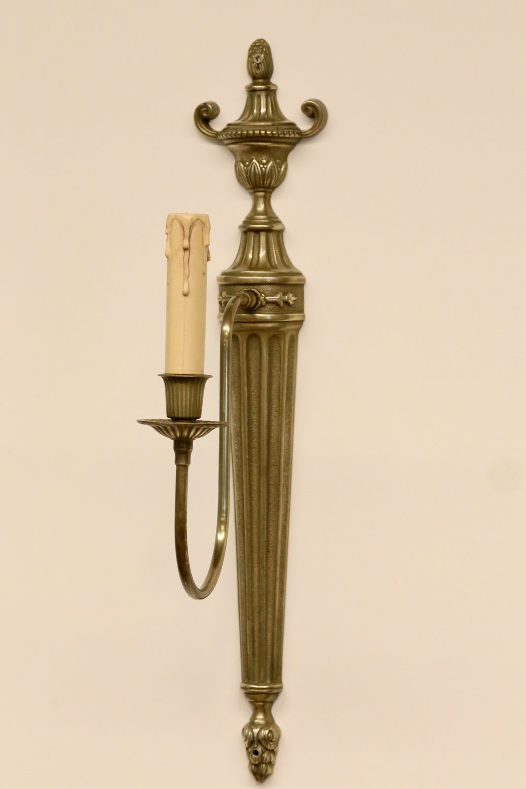French neoclassical brass wall sconce, three-quarter view