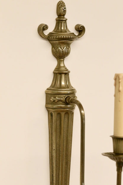 Close-up of urn finial and arm mount, neoclassical sconce