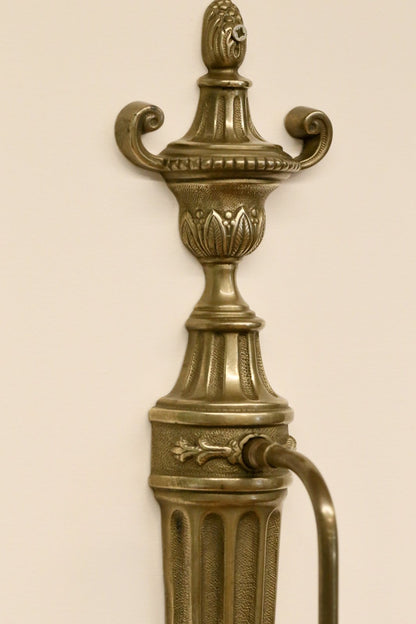 Close-up of urn finial with leaf decoration, French brass sconce
