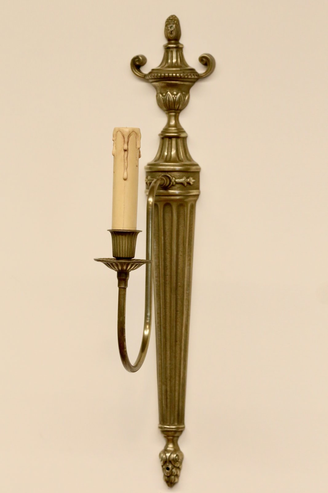 French neoclassical brass wall sconce, front view on the wall