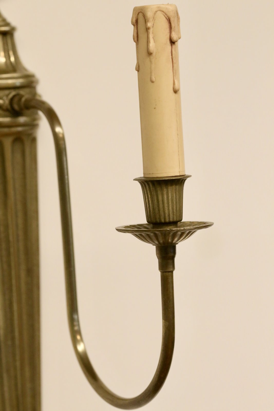 Close-up of candle sleeve and drip pan, French brass sconce
