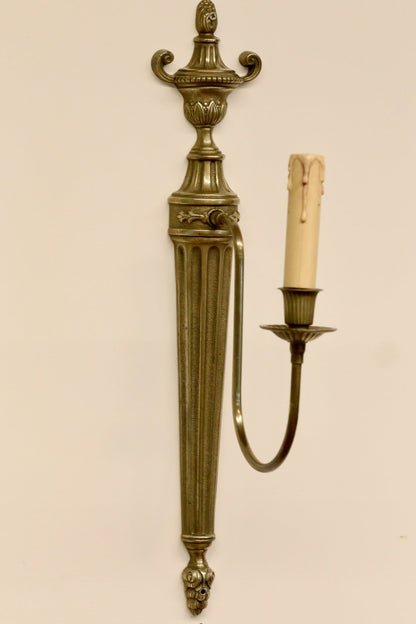 French neoclassical brass wall sconce, angled view with arm on the right