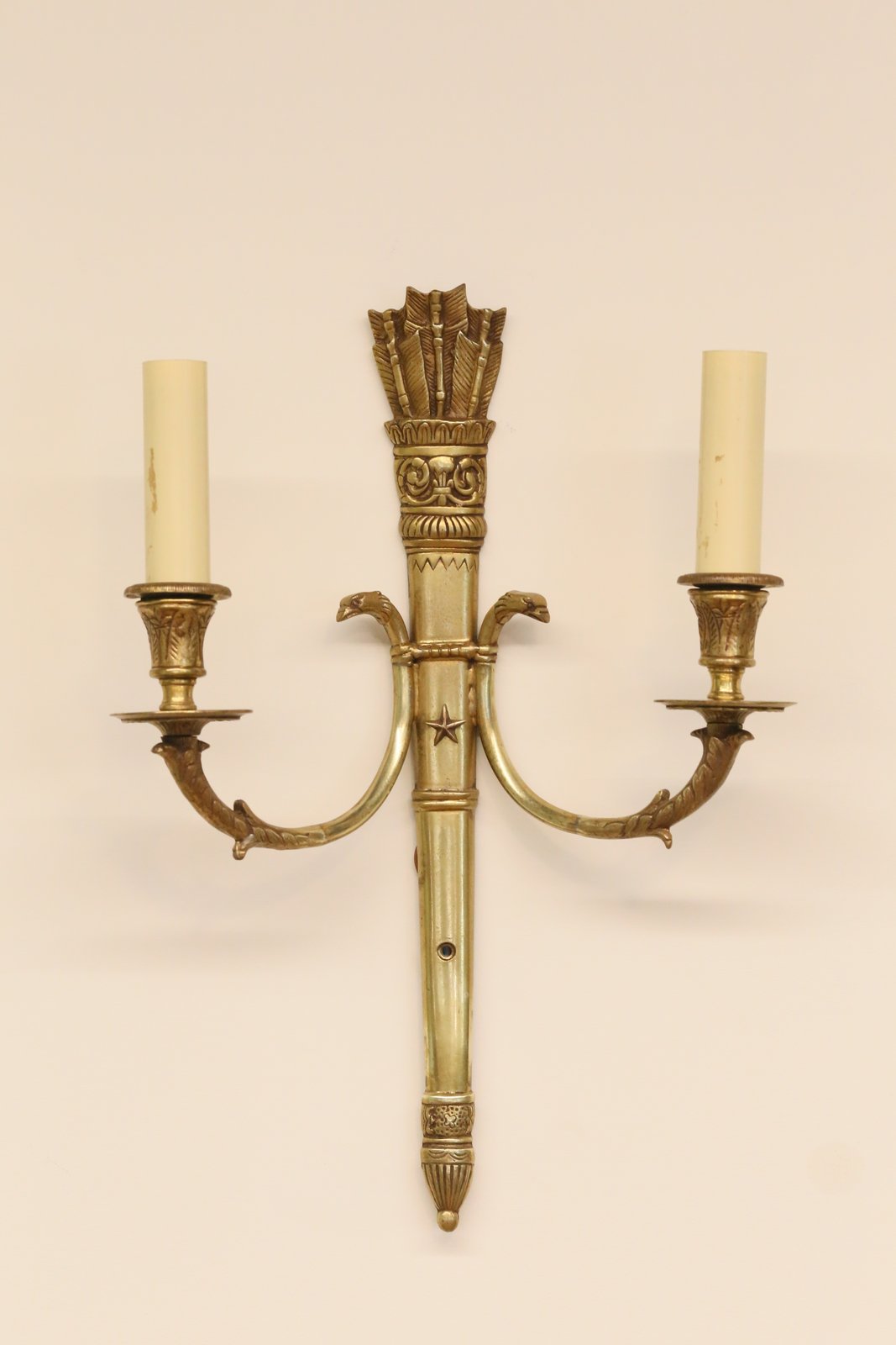 French Empire double wall sconce in ornate brass with quiver of arrows crest, swan neck arms and candle sleeves