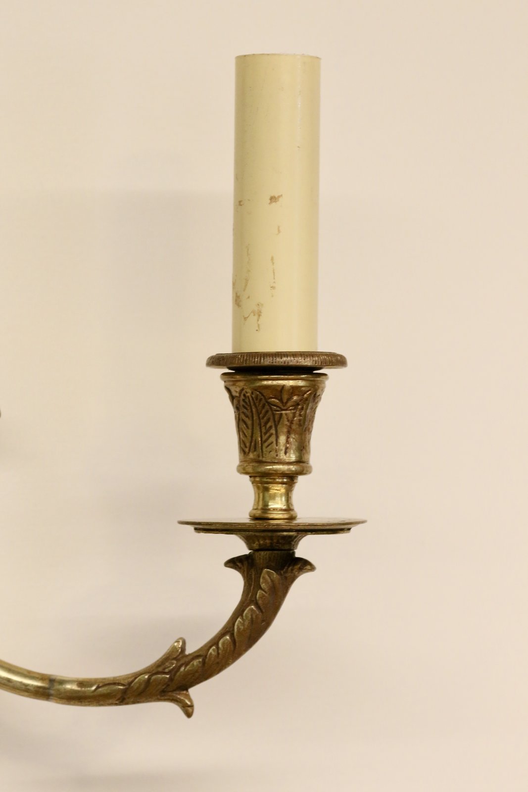 Close-up of brass candle cup, drip pan and swan neck arm
