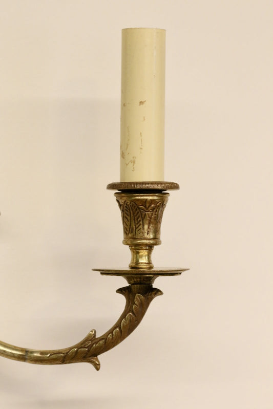 Close-up of brass candle cup, drip pan and swan neck arm