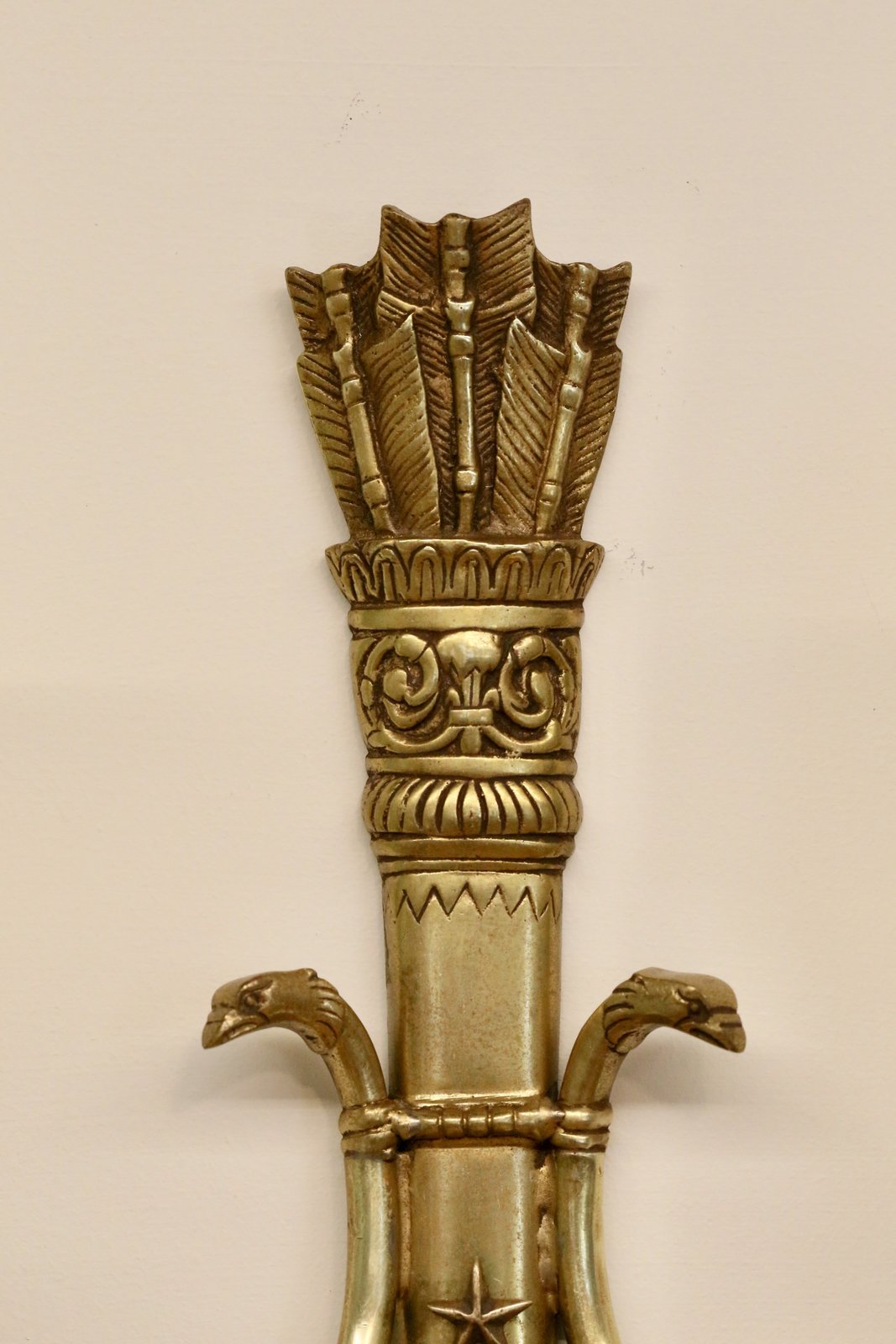 Close-up of quiver of arrows crest on the French Empire sconce