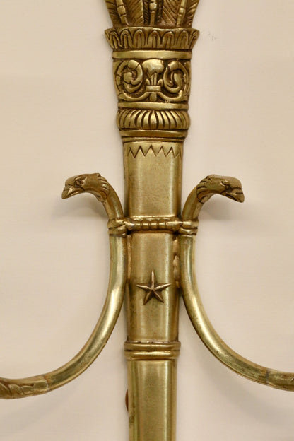 Close-up of swan head arm mounts and star motif on the sconce backplate