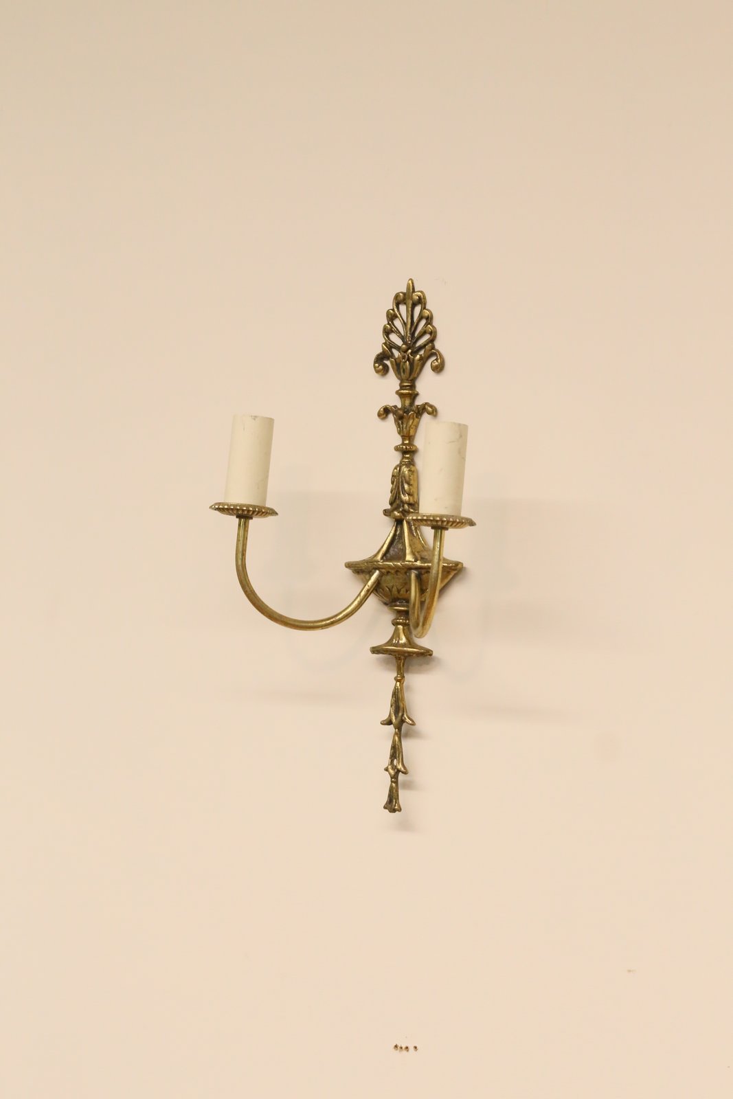 French Empire gilt brass double sconce on the wall, full view