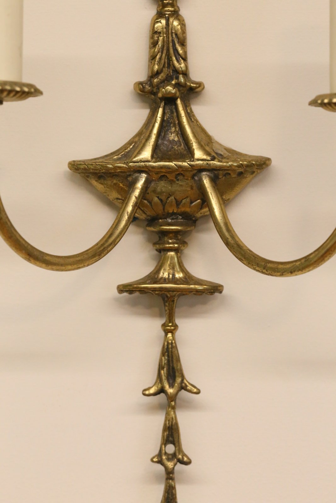 Close-up of urn body and arm junction, gilt brass sconce