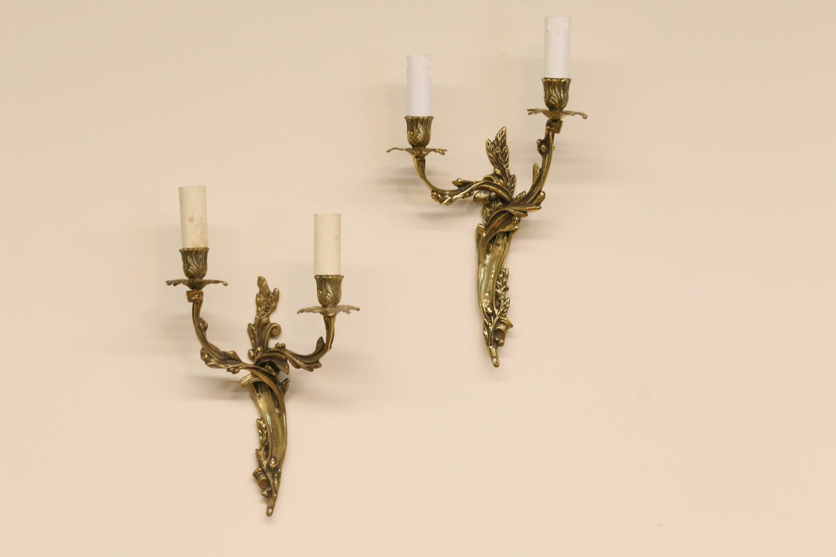 Pair of vintage French Louis XV style gilt brass two-arm wall sconces with scrolling foliate arms