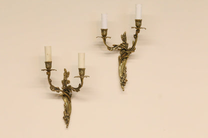 Pair of vintage French Louis XV style gilt brass two-arm wall sconces with scrolling foliate arms