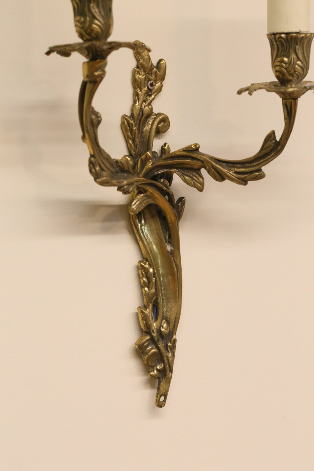 Close-up of gilt brass sconce arms and backplate