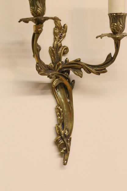 Close-up of gilt brass sconce arms and backplate