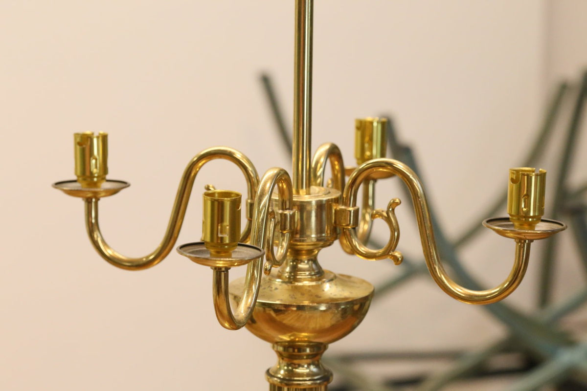 Close-up of curved brass candle arms and sockets