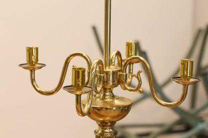 Close-up of curved brass candle arms and sockets