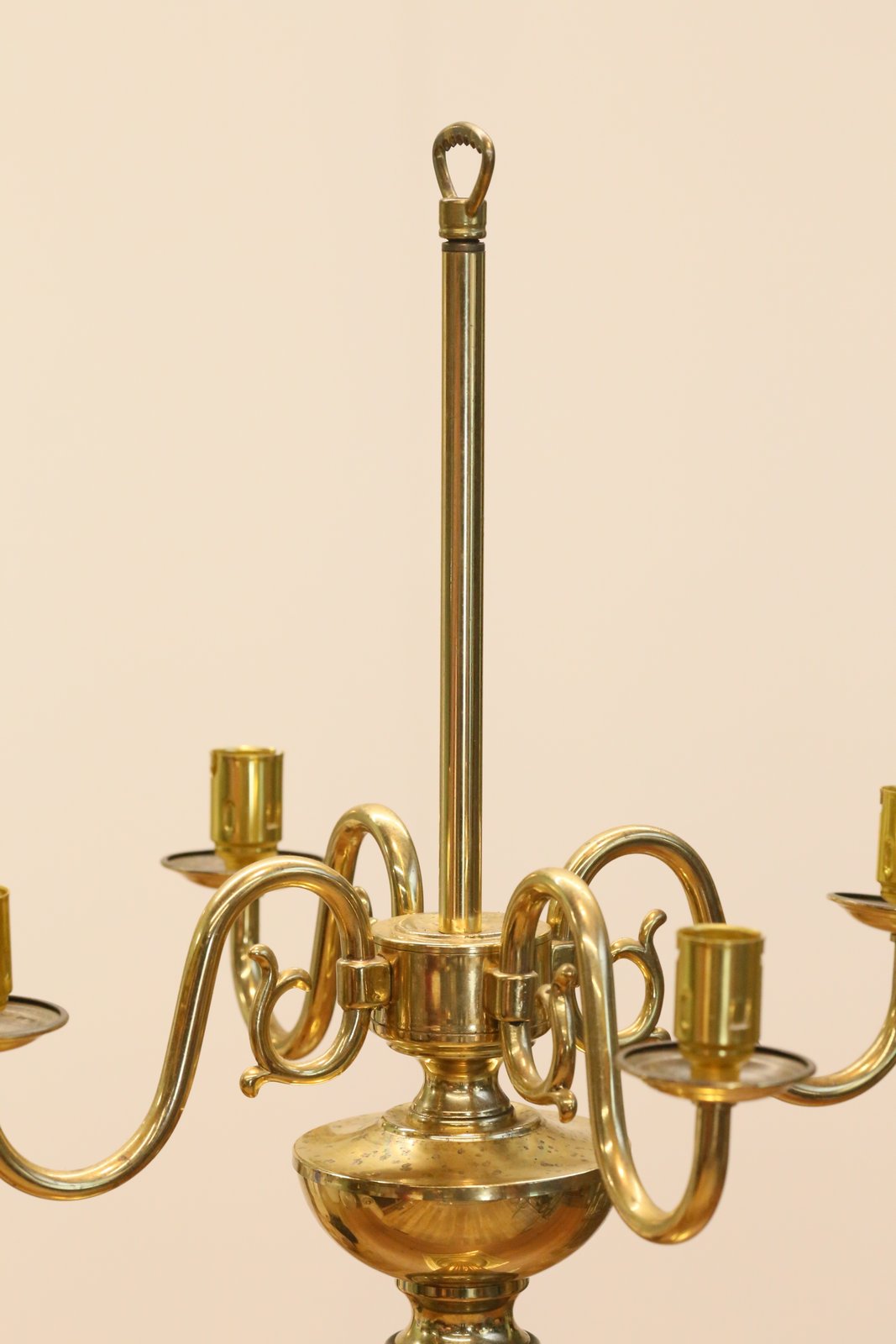 Close-up of brass candelabrum arms and central stem with ring finial