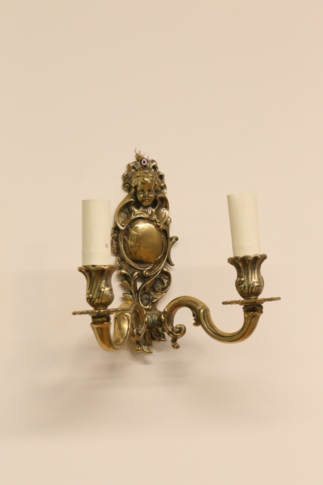 Italian brass cherub wall sconce, three-quarter view