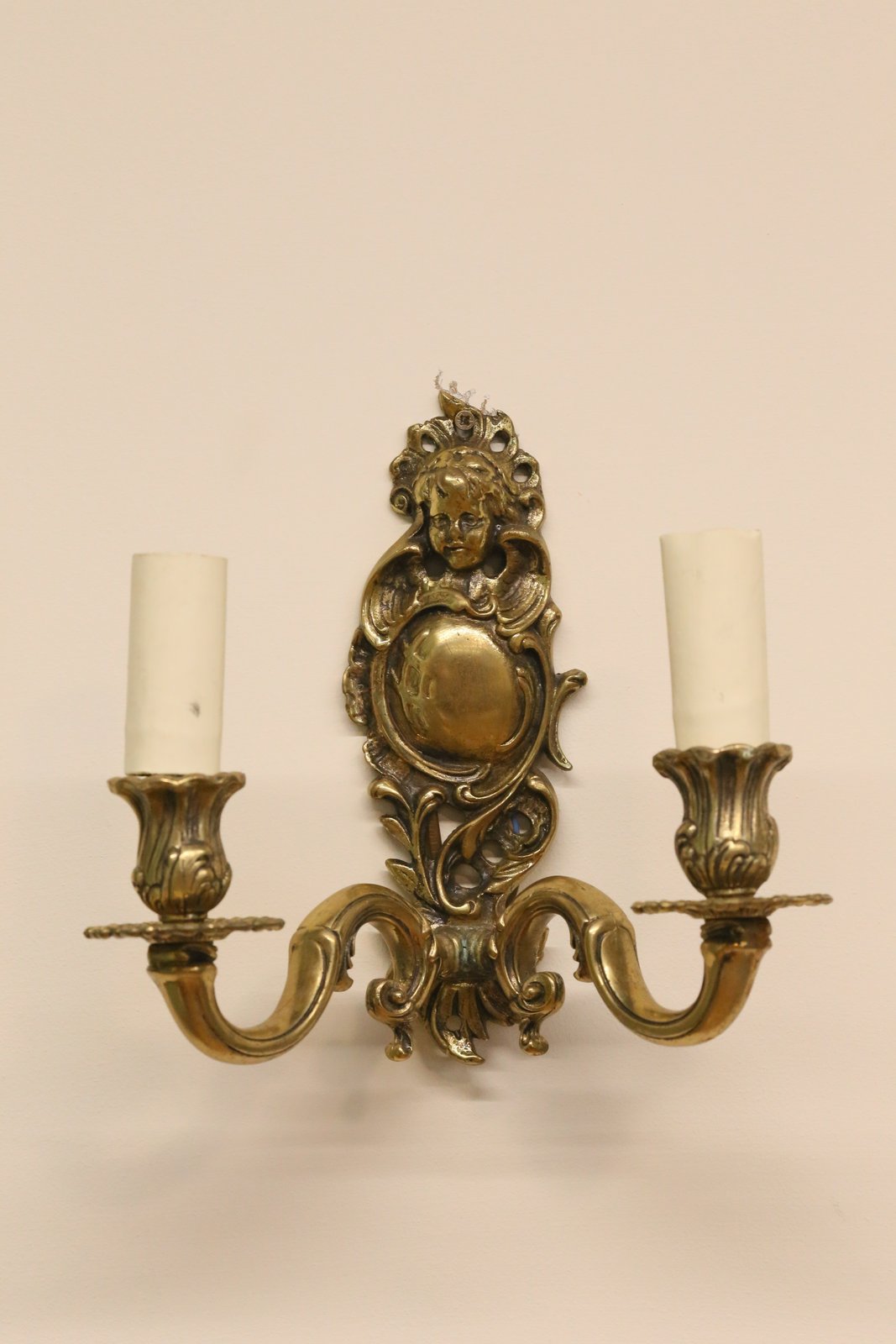 Italian brass cherub wall sconce, front view