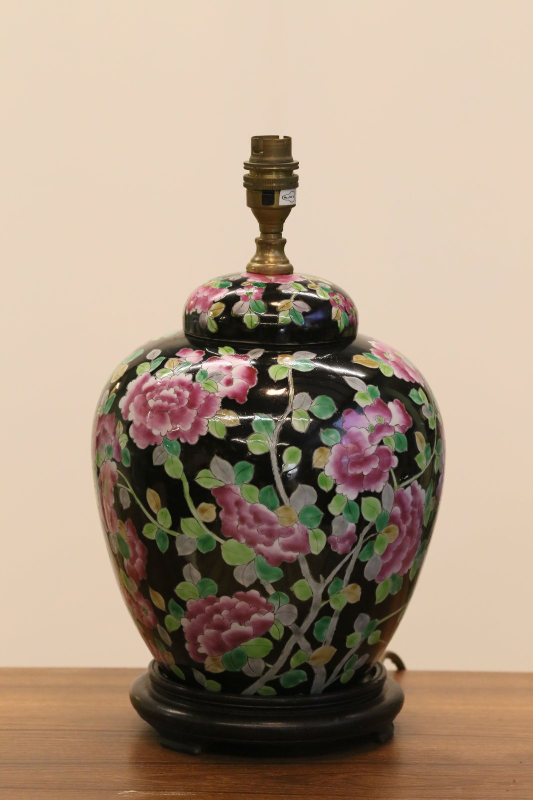 Chinese porcelain floral table lamp base on a sideboard
