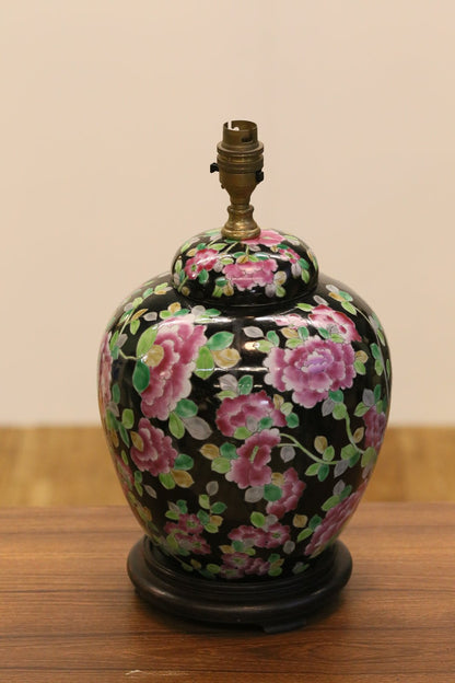 Close-up of pink peony decoration on the black porcelain lamp base