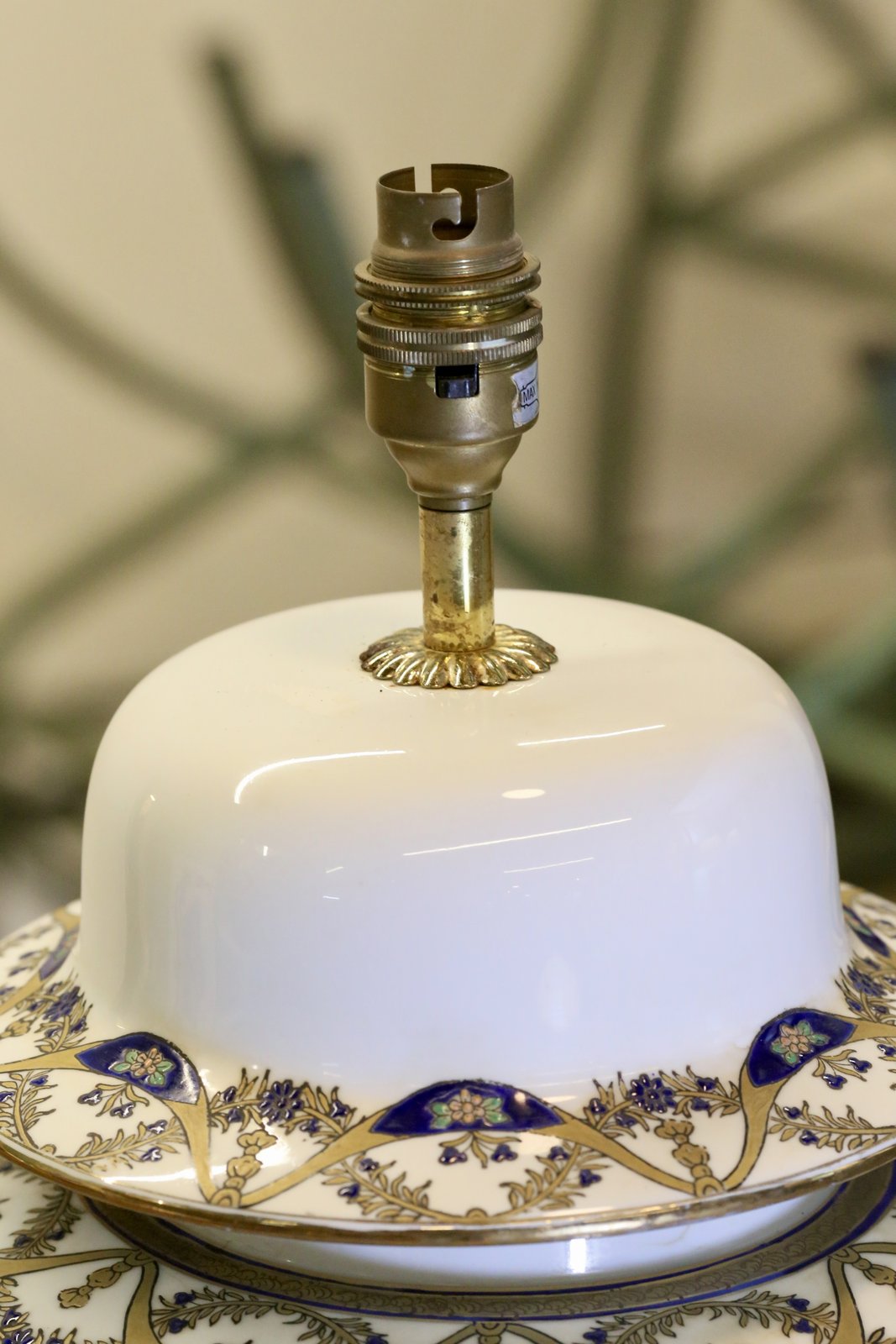 Close-up of brass bulb holder and porcelain lamp cover