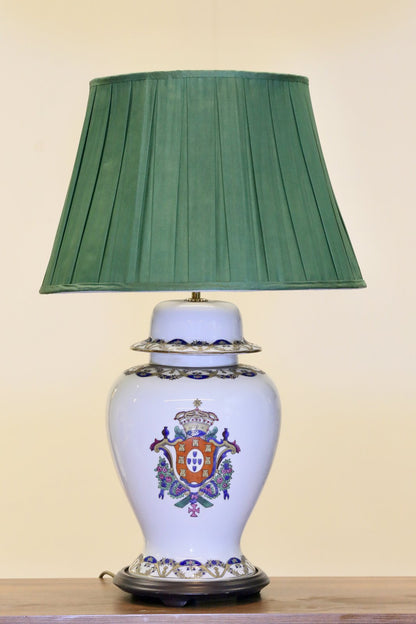 Antique Chinese armorial porcelain table lamp with green shade, studio view