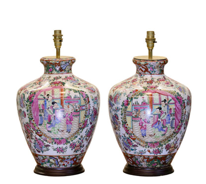 Pair of antique Chinese famille rose porcelain table lamps with court scene panels on wooden stands, 51cm