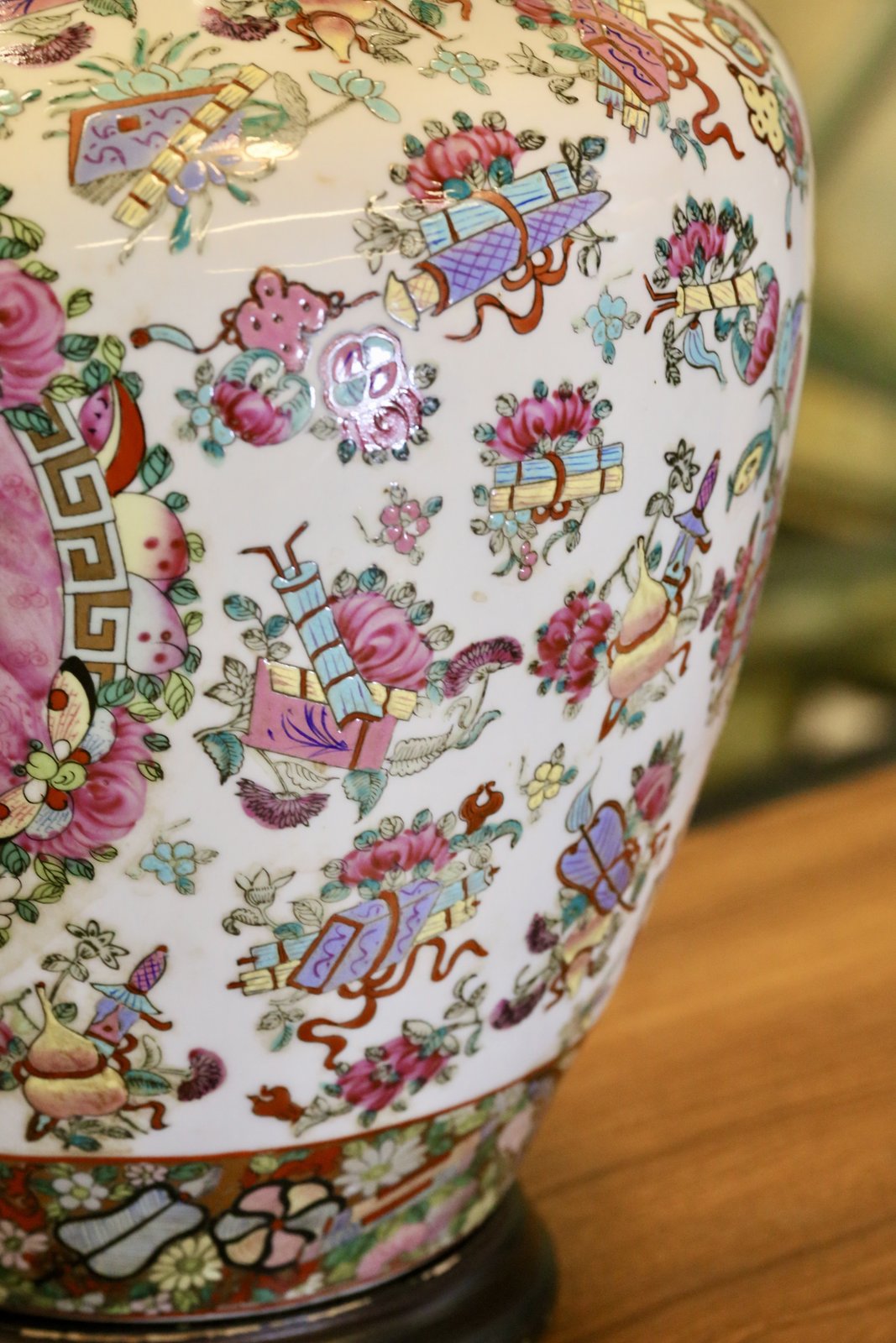 Close-up of painted precious objects and flowers on the porcelain body