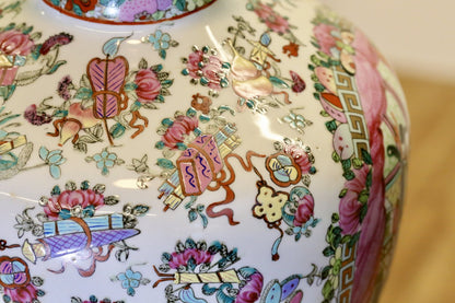 Close-up of famille rose floral and emblem decoration