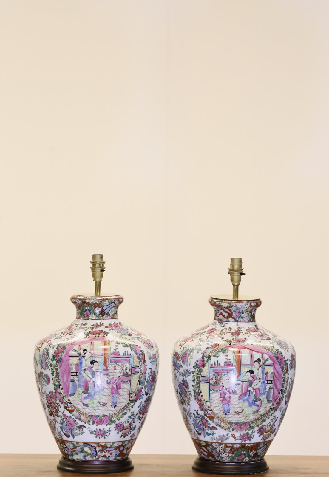 Pair of Chinese famille rose lamp bases on a sideboard