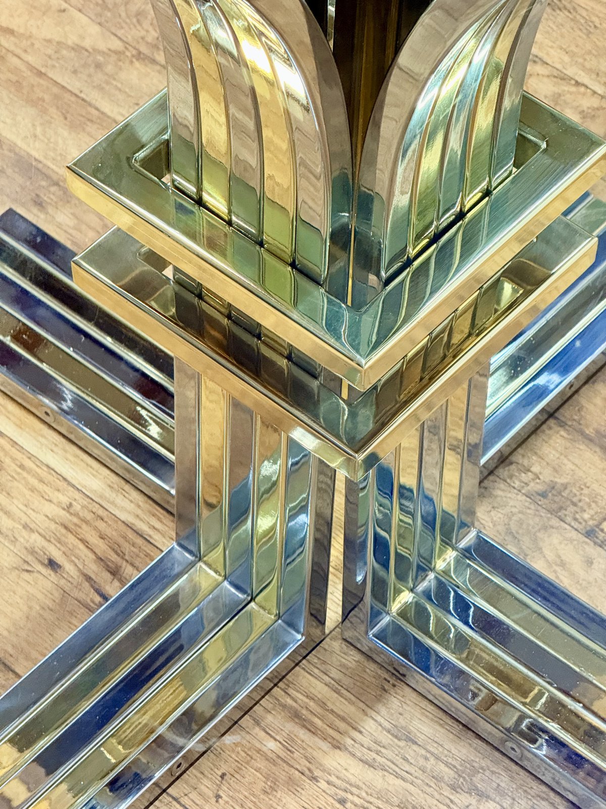 Close-up of chrome and gilt cross base from above