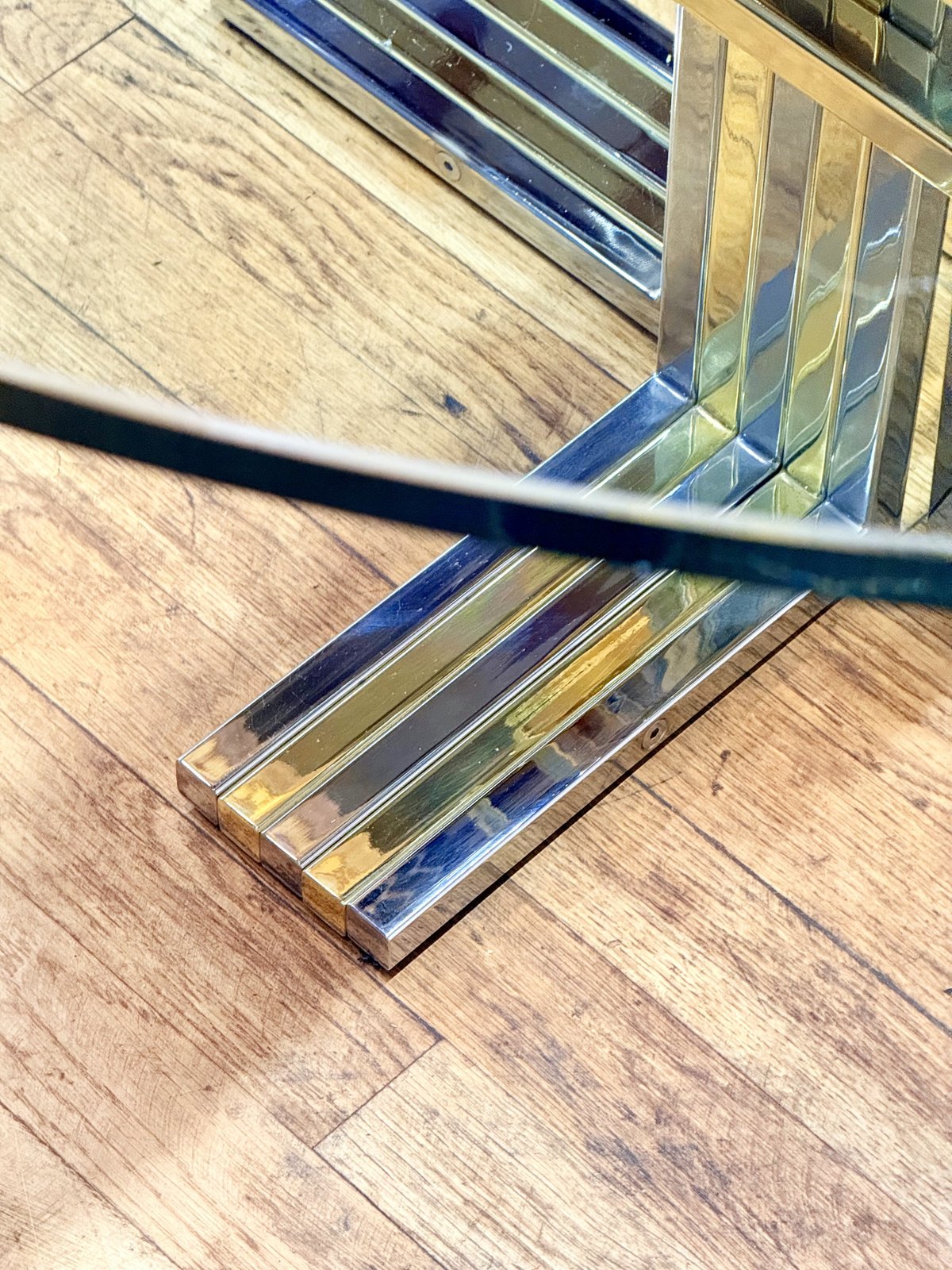 Close-up of chrome and gilt cross base foot