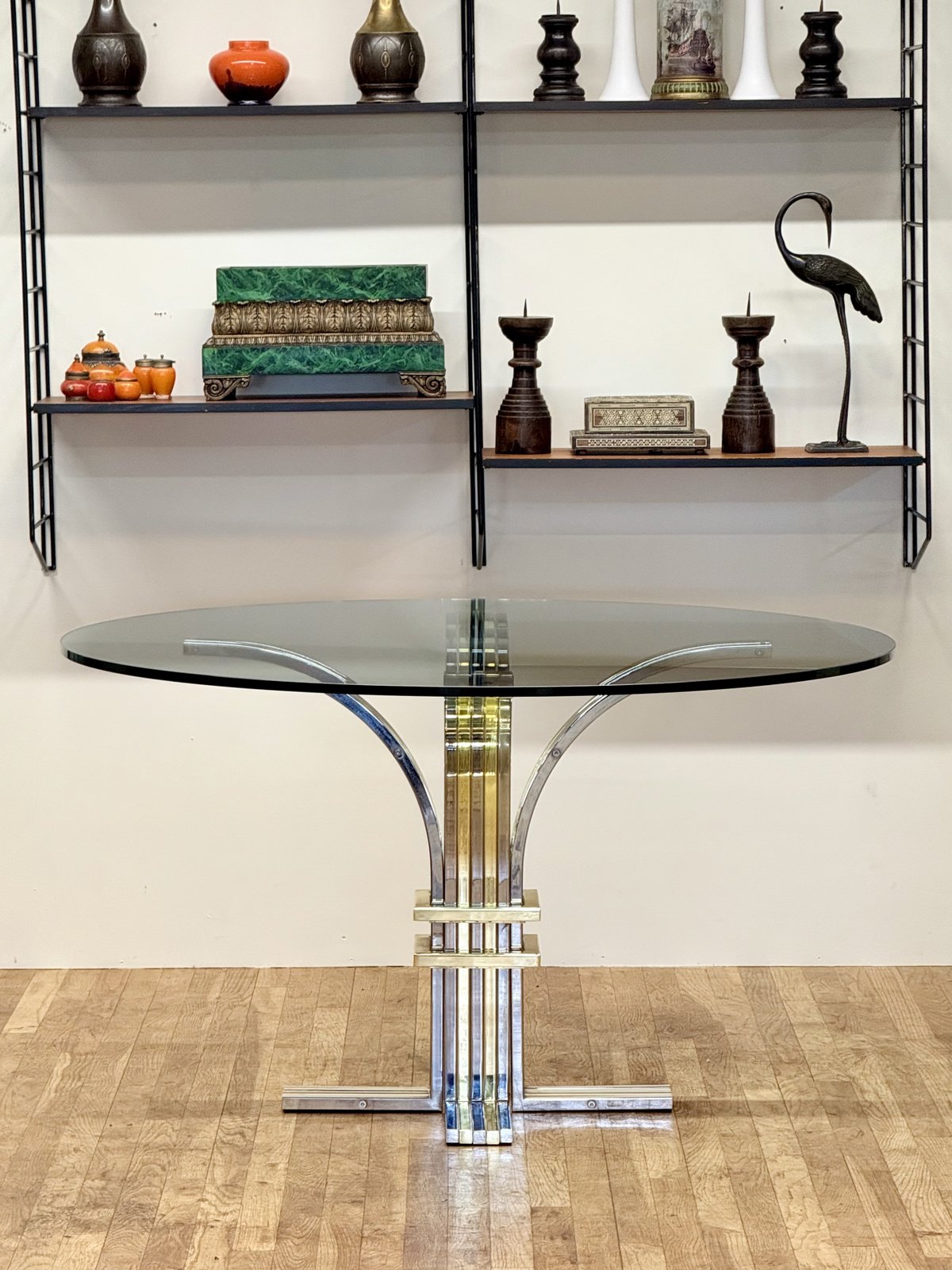 Renato Zevi chrome and brass glass centre table below wall shelving, full view