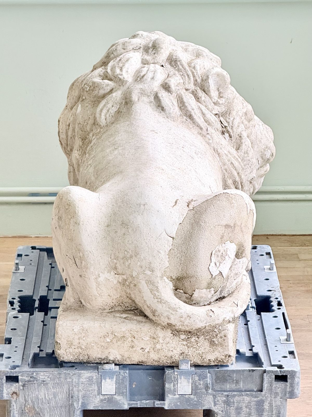 Back view of a Cast stone lion after Canova showing tail and haunches