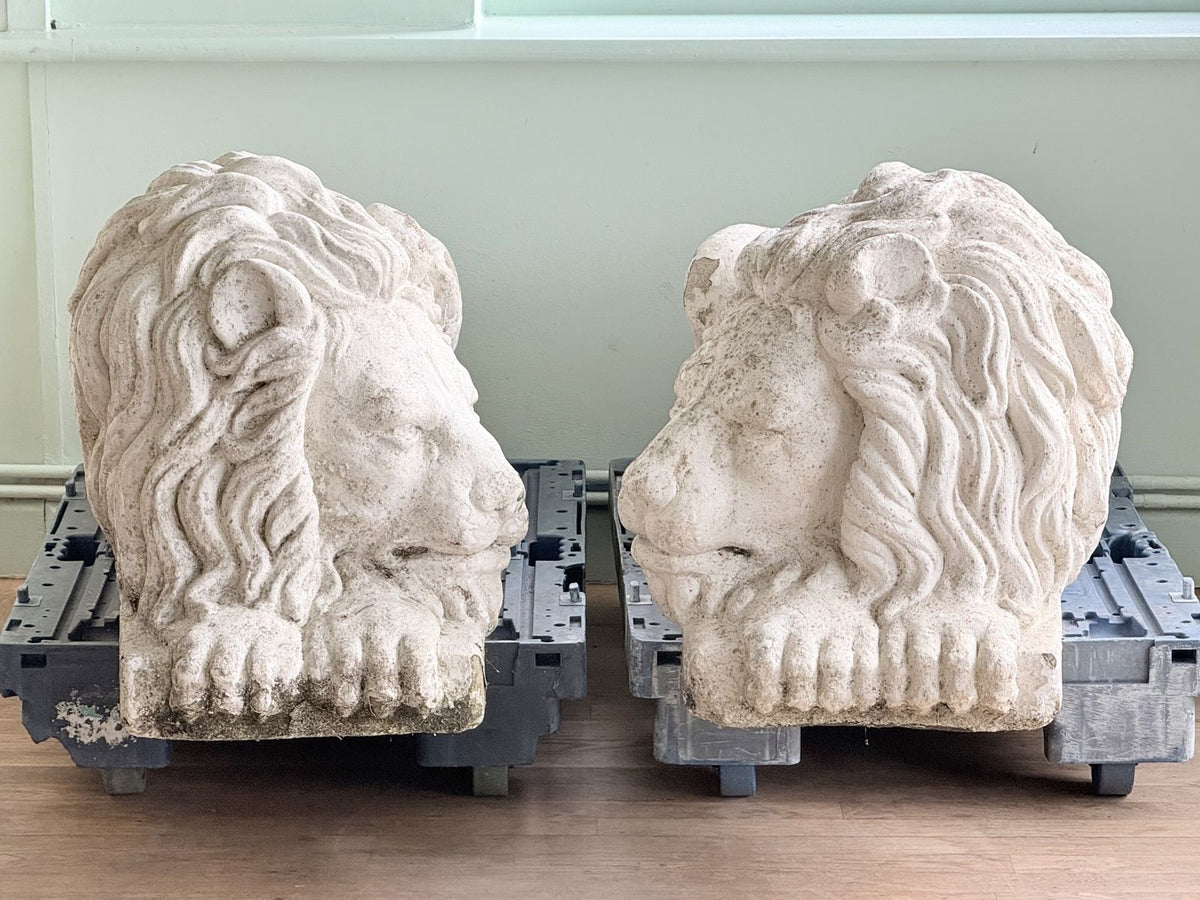 Pair of painted cast stone lions after Canova, front view on dollies