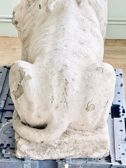 Back of the cast stone lion showing curled tail
