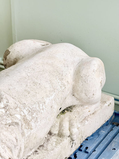 Close-up of cast stone lion haunch and plinth